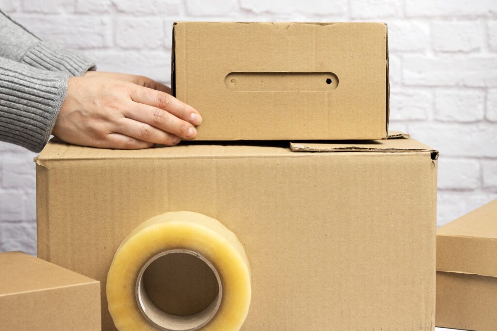 A female's hands holding cardboard boxes in the concept of relocating