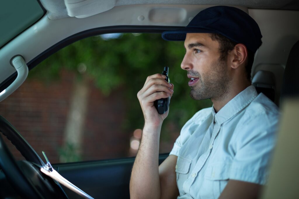 A man-and-van driver is using a radio